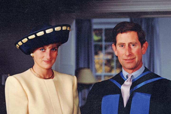 Photo of Princess Diana wearing a yellow suit, standing beside Prince Charles.