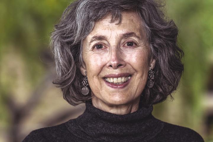 Portrait of Rosemary Knight with nature blurred in the background.