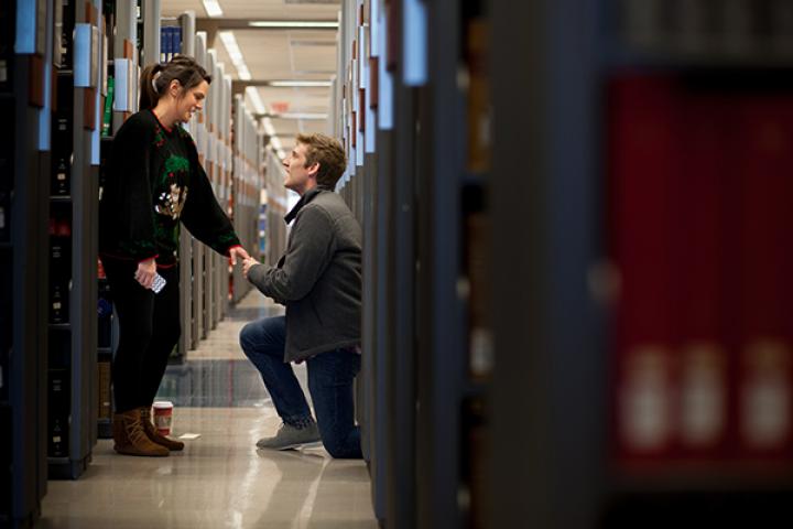 Man on bended knee proposing.