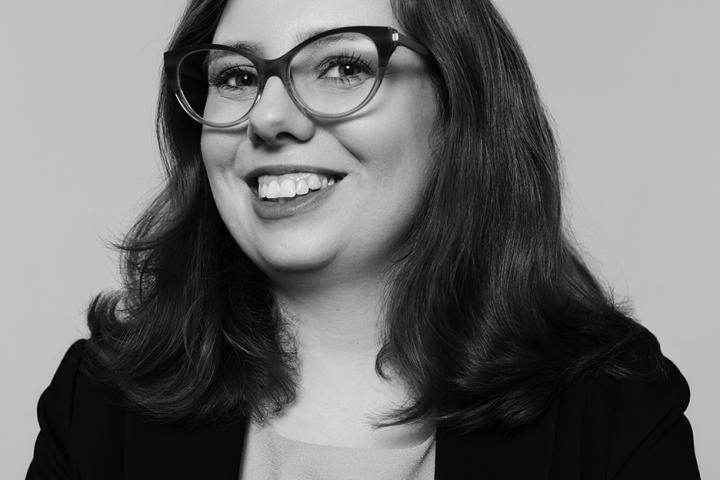 Carolyn Harris with her arms folded in front of her, smiling at the camera.
