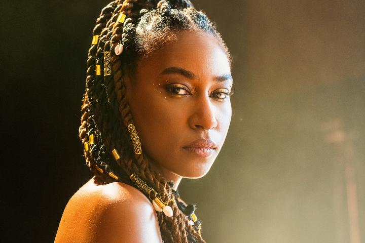 Dominique Fils Aime looks over her shoulder at the camera.