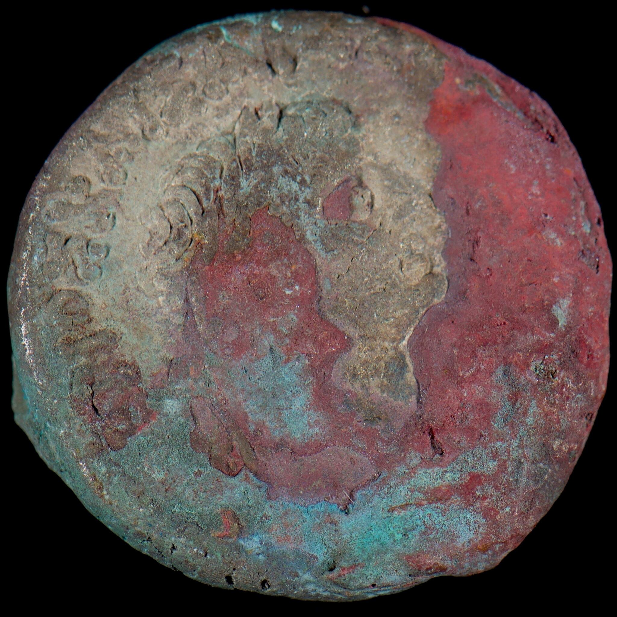 Blue and red corrosion on coin