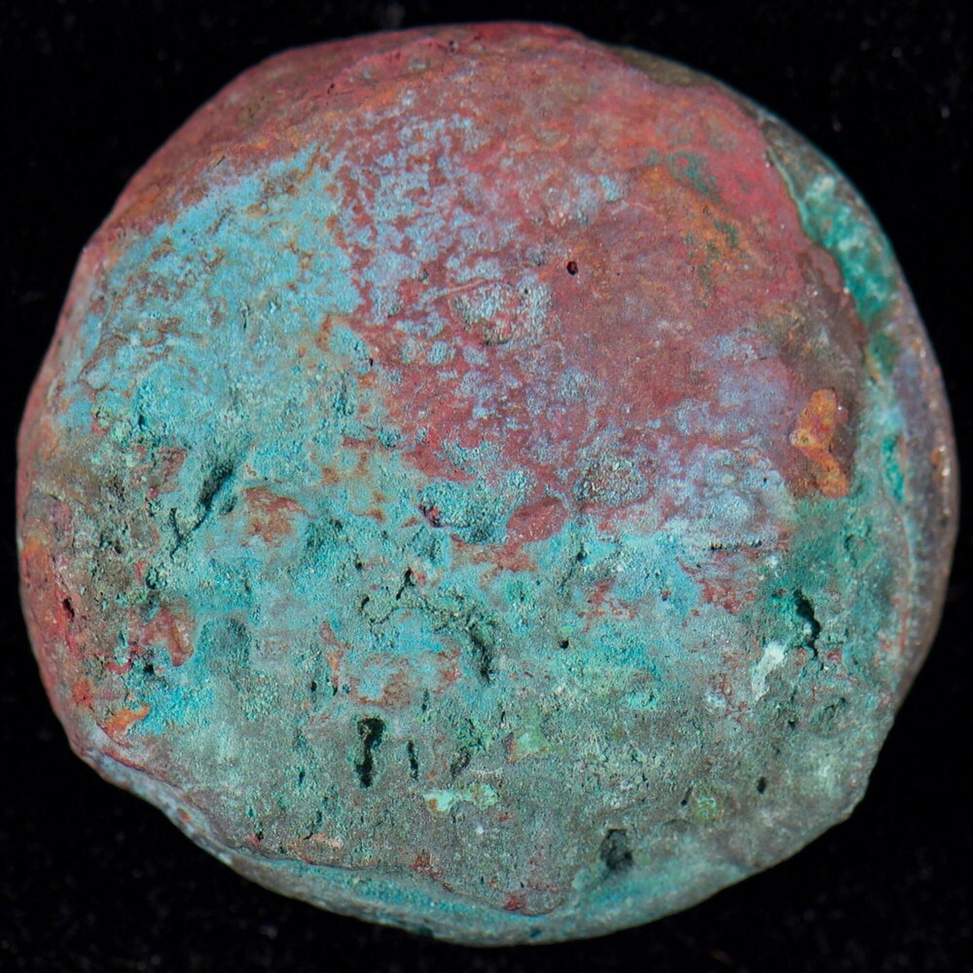 Verso of corroded coin above