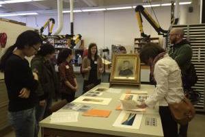 A group of people looking at art on a table