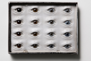 A piece of art that features 16 eyes arranged in a rectangle