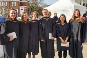 Six people smiling at a graduation ceremony