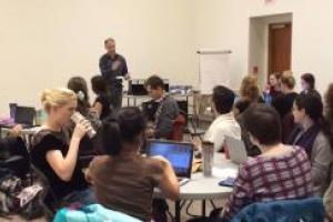 People in a room with a speaker