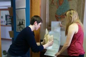 Two people working on a piece of art