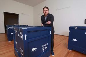 A person standing in a room full of crates