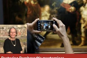 A person taking a picture on their phone of a piece of art