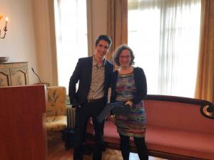 Two people smiling in a room