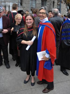 Two people smiling at a convocation