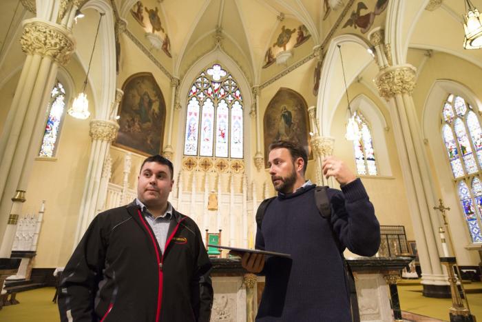 Two people having a conversation in a cathedral