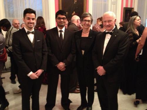 Four people smiling at an event