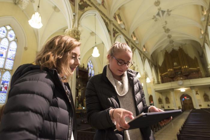 Two people using a tablet in a Cathedral