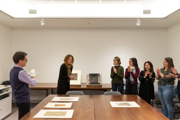 People talking around a table that has art on it