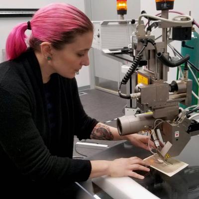 A person using equipment on a piece of art