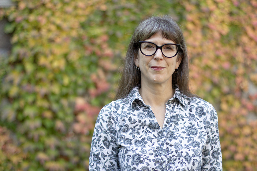Associate Dean (Academic) Jenn Stephenson standing in front a wall of ivy.