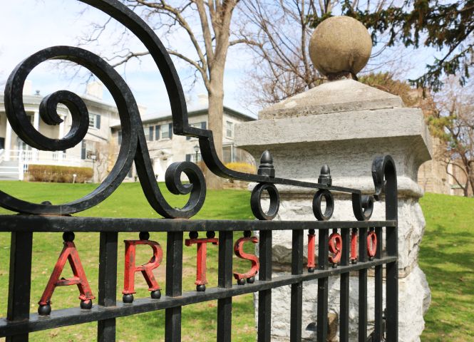 Queen's Campus fence that says Arts 1910