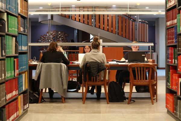 Students working at a table in Stauffer Library.