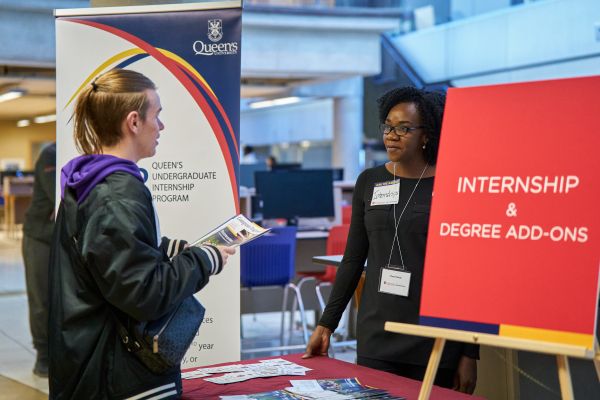 Student speaking with a staff member about internship opportunities.