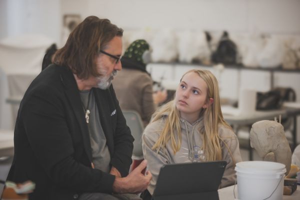 Teacher talking to a student.