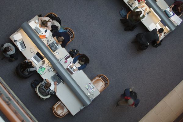 Students writing and studying in the library