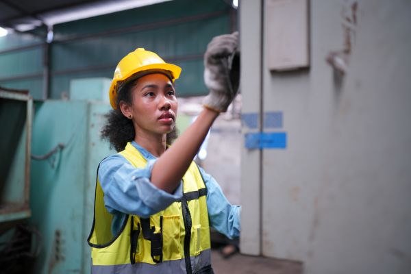 Factory Female Industrial Engineer Works in metal working factory