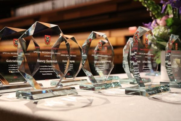 Glass awards with names sitting on a table