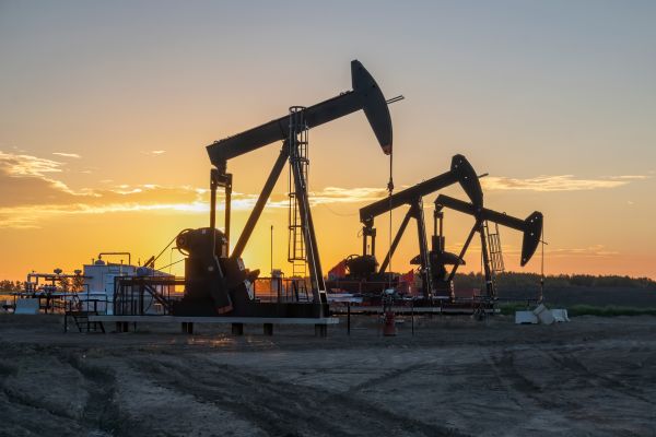 Oil wells with a sunset in the background