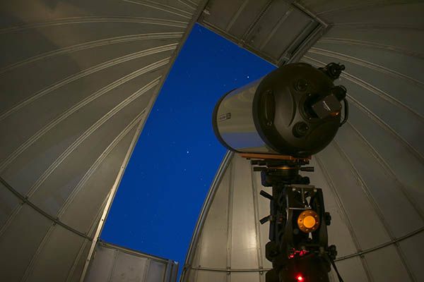 The Queen's University Observatory at night.