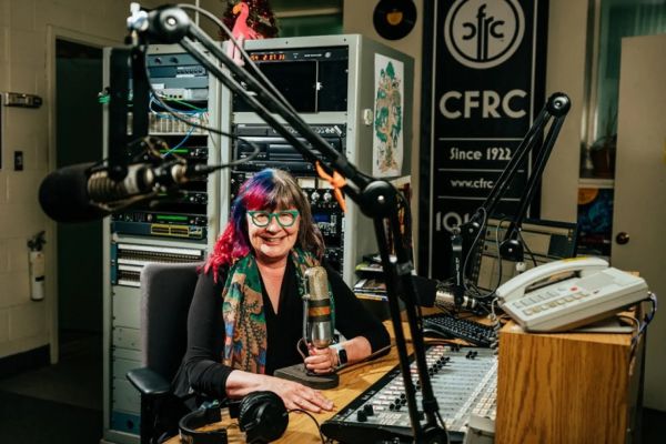 Shelagh Rogers sitting in a radio studo.