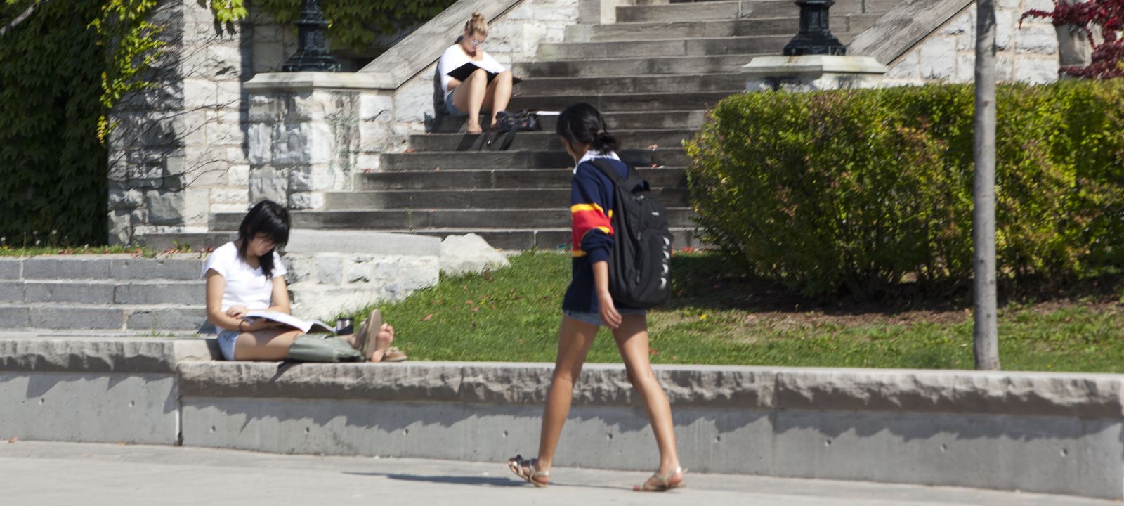 Student wearing shorts walking on campus
