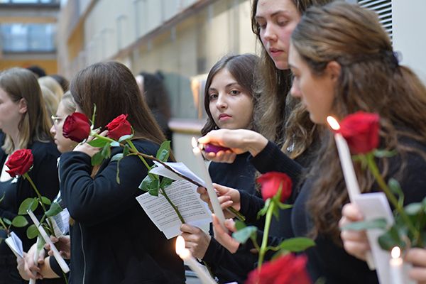 Queen's Engineering and Applied Science students, staff, and faculty lighting candles.