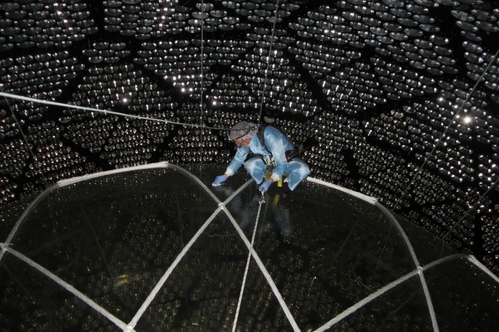 Dr. Peter Skensved is the only person to ever access the top of the acrylic SNO+ detector in order to perform a small modification to its surface. [Credit: Dr. Mark Chen]