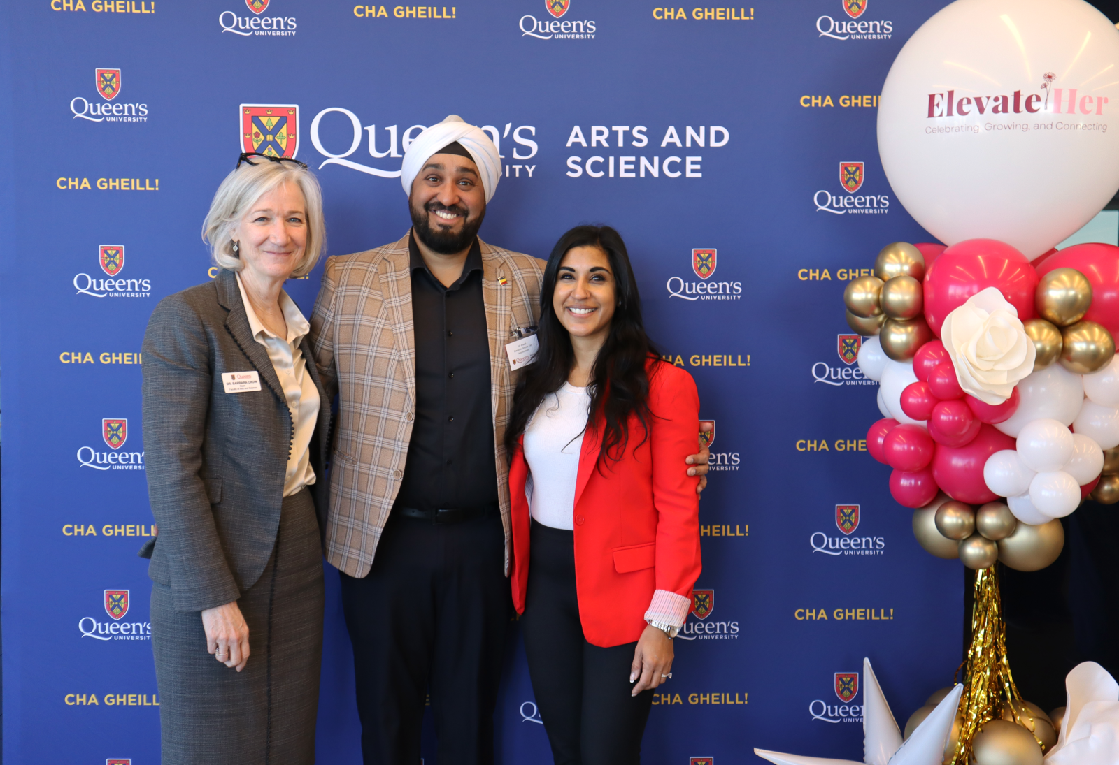 KP Anand and Barbara Crow posing in front of Arts and Science blue backdrop at ElevateHer