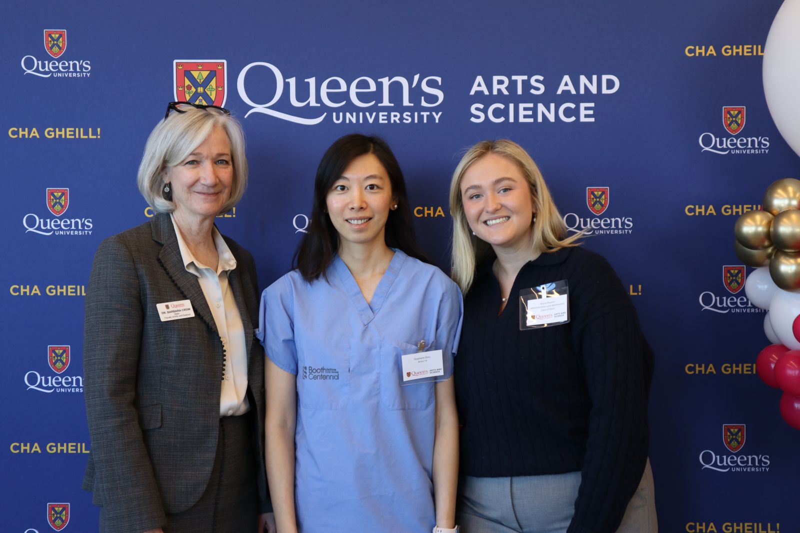 Barbara Crow, Stephanie Zhou, and Brynn Paxton posing in front of Arts and Science blue backdrop at ElevateHer