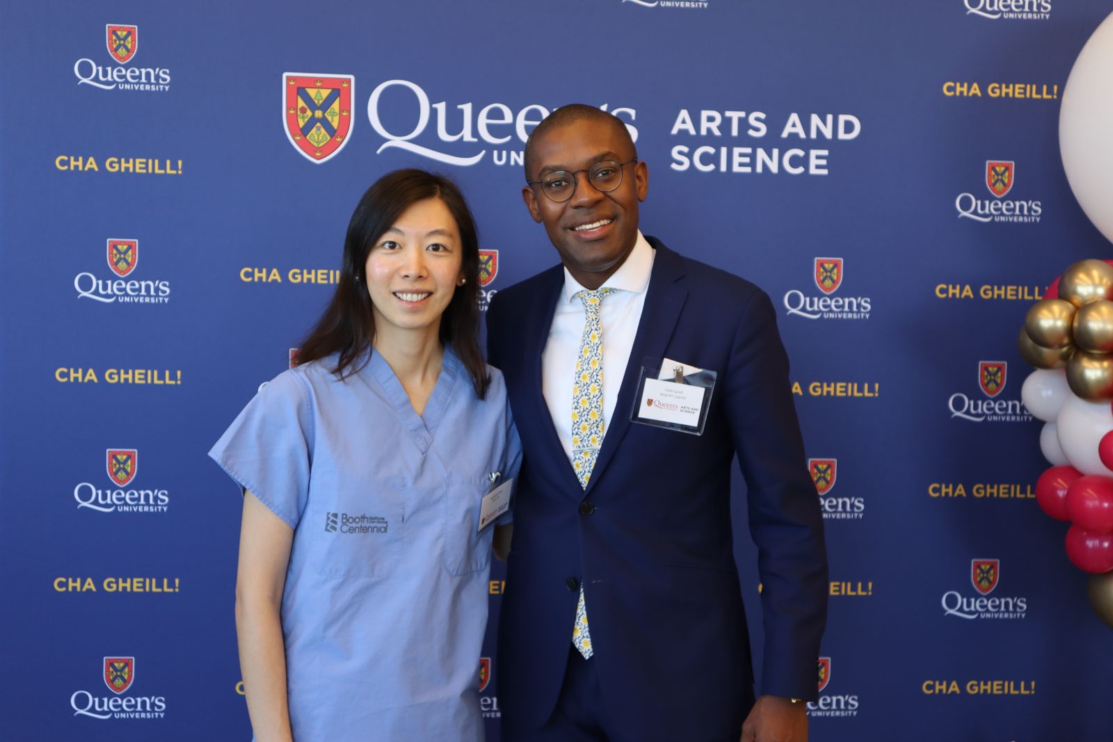 Stephanie Zhou and Colin Lynch posing in front of Arts and Science blue backdrop at ElevateHer