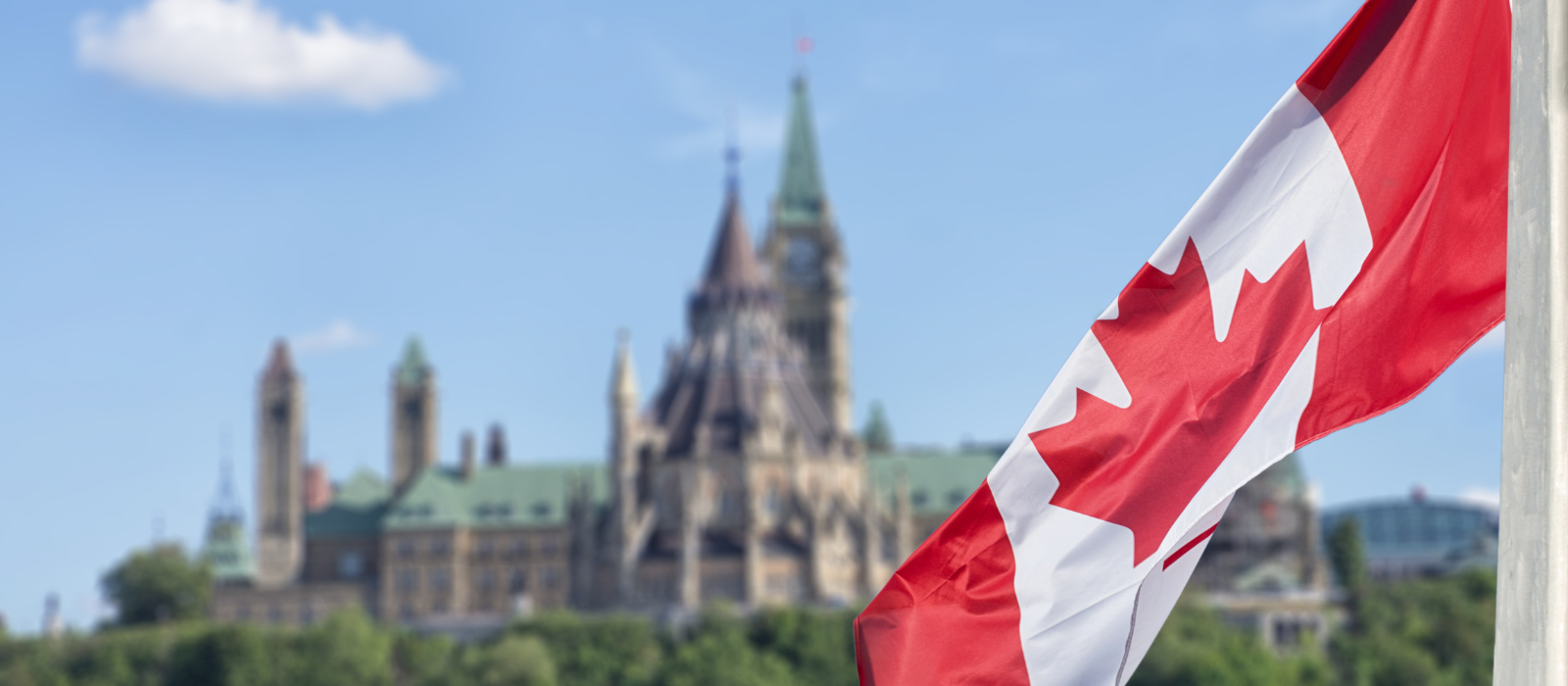 Canadian flag in front of the Parliament buildings.