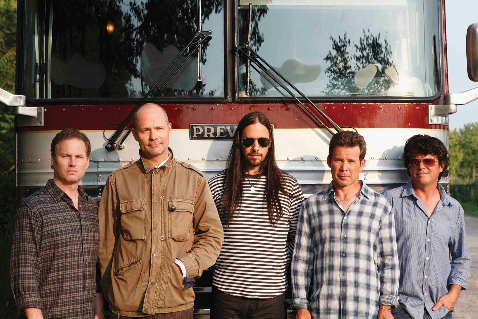 The Tragically Hip standing in front of a bus