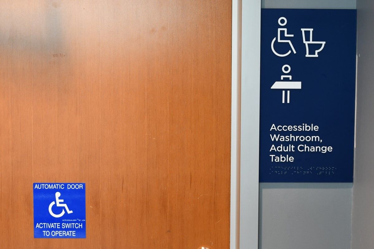 Signs on a bathroom door indicating that it is accessible.