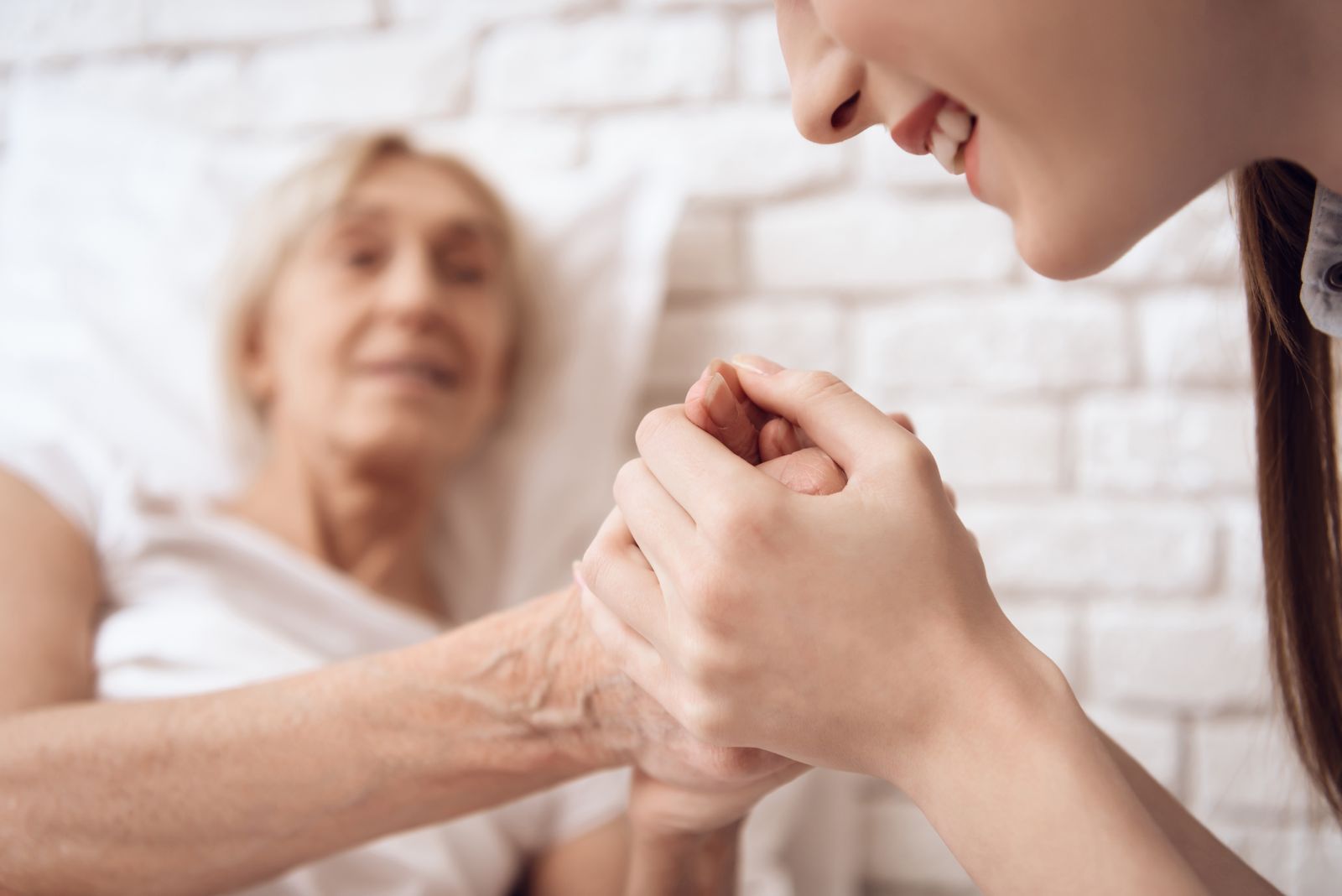Care worker holding an elderly's hands