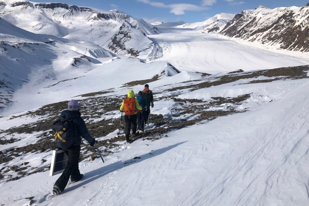 Return hike from servicing a climate data telemetry station on White Glacier Hill, May 2023. From left to right, Madeline Myers (ICELab PhD Candidate), Dr. Alison Criscitiello (University of Alberta), Sofia Guest (ICELab MSc student), and Miles Ecclestone (Trent University).