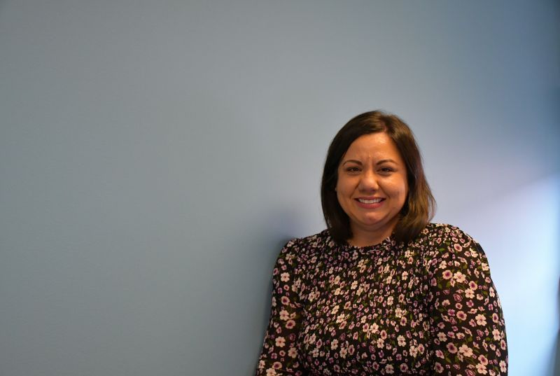 Miranda Gavidia standing in front of a blue wall