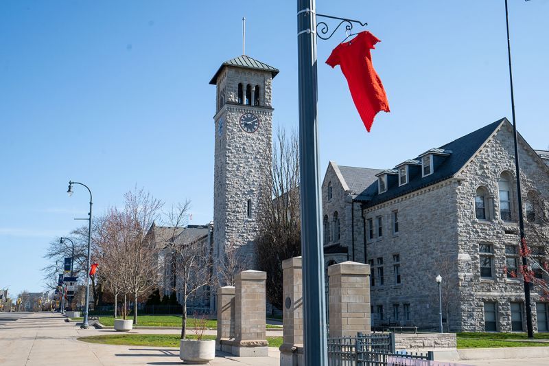 Red dresses line the Queen’s campus’ main thoroughfare today marking the National Day of Awareness for Missing and Murdered Indigenous Women, Girls, and Gender Diverse People. (Queen's University)