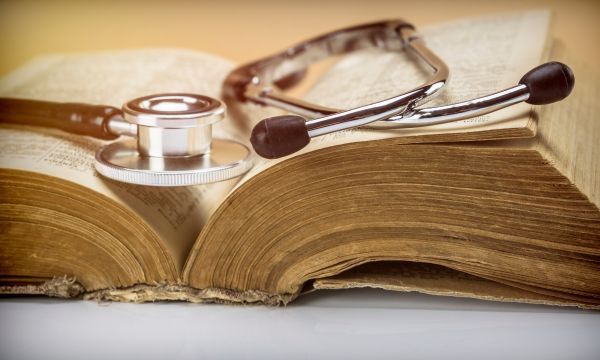 Stethoscope on an old book of medicine