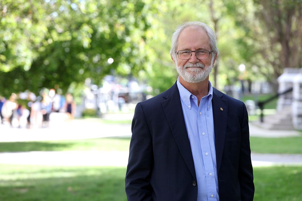 Principal Patrick Deane standing outside 