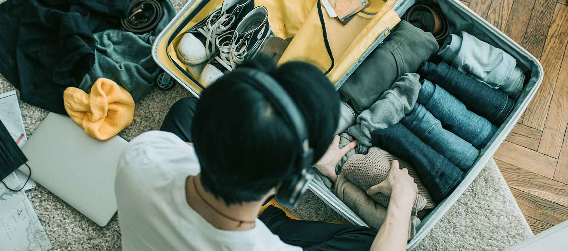 A student packing a suitcase