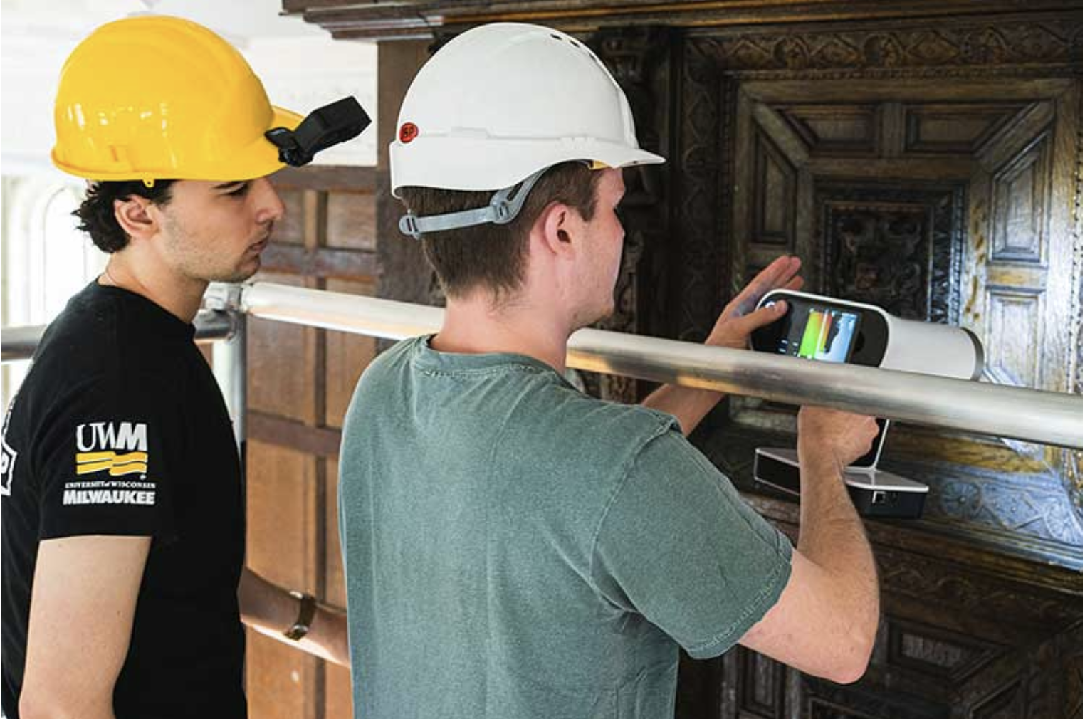 UWM students take technical measurements while working at Bader College., UWM students take technical measurements while working at Bader College.