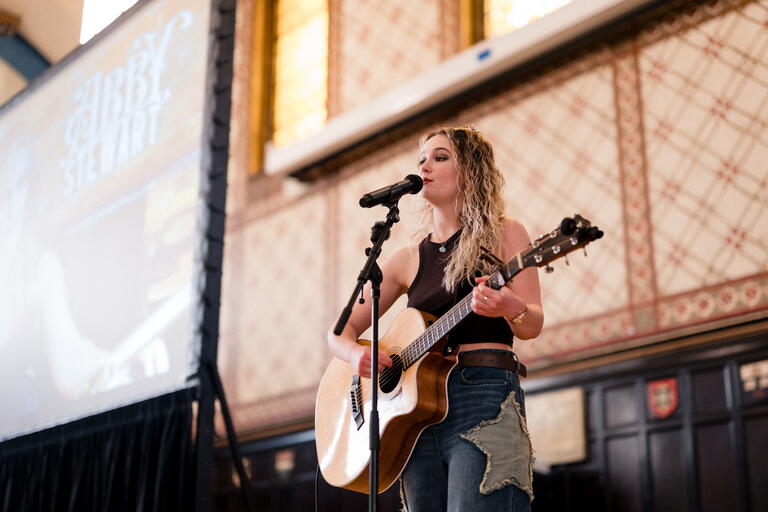 Abby Stewart performing with guitar